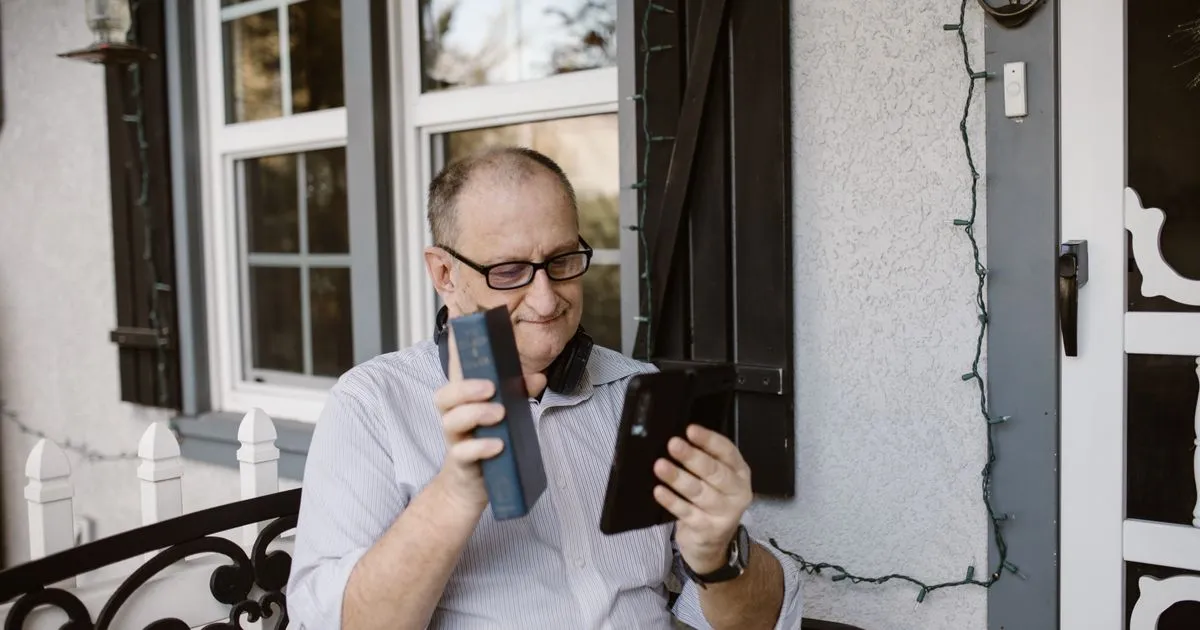 Senior man smiling while making a phone call on his porch