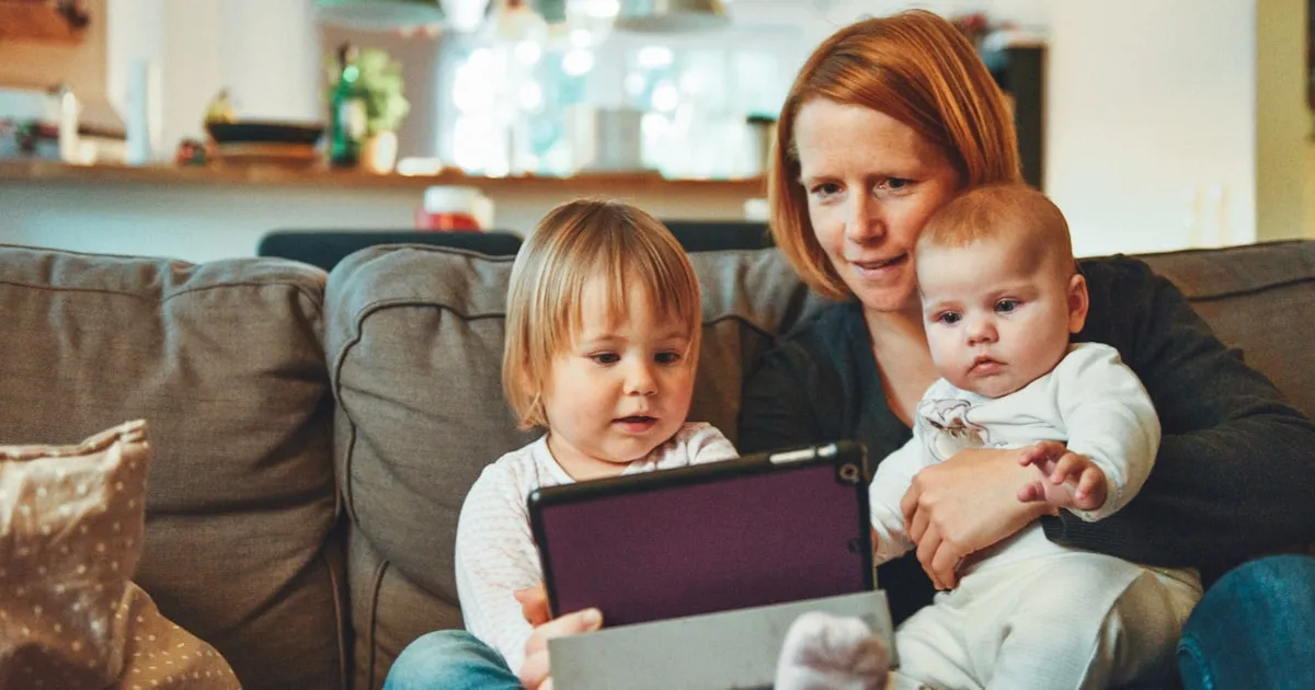 Grandparent and grandchild reading a book together at home