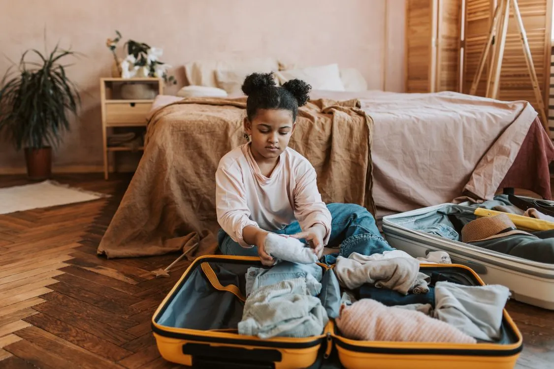 Child packing their bag with their own stuffed animal for a sleepover